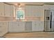 Kitchen with stainless steel appliances, white cabinets, and a window view at 210 Grandchester Way, Fayetteville, GA 30215