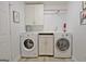Functional laundry room with washer, dryer, cabinets, and countertop space at 210 Grandchester Way, Fayetteville, GA 30215