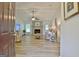 Spacious living room features wood floors, a ceiling fan, and a painted brick fireplace at 210 Grandchester Way, Fayetteville, GA 30215
