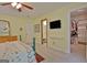 This spacious bedroom features a TV and convenient access to an en suite bathroom and walk-in closet at 210 Grandchester Way, Fayetteville, GA 30215