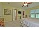 Bright main bedroom boasts a ceiling fan, TV, and an en suite bathroom with walk-in closet at 210 Grandchester Way, Fayetteville, GA 30215