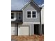 Gray two story home with white garage door and trim accents at 11598 E Lovejoy Rd # 3, Hampton, GA 30228