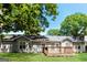 Back of home featuring a manicured lawn and a wood deck at 1421 Oak Knoll Ne Dr, Conyers, GA 30012