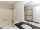 Bathroom featuring a shower-tub combination, a dark vanity, and a bright, neutral-toned interior at 1421 Oak Knoll Ne Dr, Conyers, GA 30012