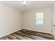 Bedroom featuring a window, neutral tones, and luxury vinyl plank flooring at 1421 Oak Knoll Ne Dr, Conyers, GA 30012