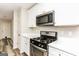 Bright kitchen features stainless steel appliances, white cabinets, and solid surface countertops at 1421 Oak Knoll Ne Dr, Conyers, GA 30012
