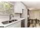Bright kitchen boasts stainless steel appliances, a double sink, and shaker cabinets at 1421 Oak Knoll Ne Dr, Conyers, GA 30012