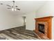 Cozy living room with a fireplace, ceiling fan, and stylish flooring at 1421 Oak Knoll Ne Dr, Conyers, GA 30012