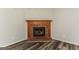 Inviting living room with a brick fireplace and wood-look flooring at 1421 Oak Knoll Ne Dr, Conyers, GA 30012