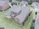 Birds eye view of a brick home featuring a covered patio and manicured lawn at 3368 Alhambra Cir, Hampton, GA 30228