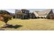 Brick house exterior featuring a green lawn and a covered patio area at 3368 Alhambra Cir, Hampton, GA 30228