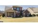 A well manicured backyard with a covered patio is attached to this brick home at 3368 Alhambra Cir, Hampton, GA 30228