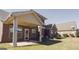 Brick house backyard with a covered patio on a sunny day at 3368 Alhambra Cir, Hampton, GA 30228