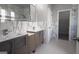 Dual sink bathroom features modern cabinets, marble accents, and ample lighting at 3368 Alhambra Cir, Hampton, GA 30228