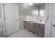 Bathroom features dual sinks with modern marble accents and bright lighting above at 3368 Alhambra Cir, Hampton, GA 30228