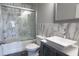 Modern bathroom features white marble tiled walls, glass shower doors, and a sleek vessel sink at 3368 Alhambra Cir, Hampton, GA 30228