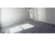 Bedroom featuring carpet floor, neutral walls, baseboard trim, and two bright doors at 3368 Alhambra Cir, Hampton, GA 30228