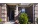 Inviting front entrance featuring a brick facade and a well-maintained garden at 3368 Alhambra Cir, Hampton, GA 30228