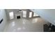 Open living room featuring modern light fixtures and white tile floors at 3368 Alhambra Cir, Hampton, GA 30228