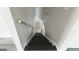 Staircase with a metal handrail and dark wood stairs and white walls at 3368 Alhambra Cir, Hampton, GA 30228