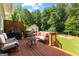 Inviting back deck with outdoor seating and a grill, perfect for entertaining and enjoying the beautiful backyard at 431 Hampton Grn, Peachtree City, GA 30269