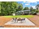 Picturesque backyard featuring a fire pit, lush green lawn, and a charming storage shed at 431 Hampton Grn, Peachtree City, GA 30269