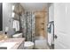 Updated bathroom featuring tiled shower-tub combo, neutral color scheme, and decorative baskets at 431 Hampton Grn, Peachtree City, GA 30269