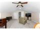 Bright bedroom with a television, sitting chair, and ceiling fan, creating a comfortable and inviting atmosphere at 431 Hampton Grn, Peachtree City, GA 30269