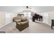 Spacious bedroom with a bed, arm chair, and desk, providing a comfortable and versatile living space at 431 Hampton Grn, Peachtree City, GA 30269