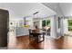 Open dining room with hardwood floors, sliding glass doors to the deck, and an adjacent modern kitchen at 431 Hampton Grn, Peachtree City, GA 30269