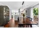 View of the dining area with hardwood floors, a modern light fixture, and access to the outdoor deck at 431 Hampton Grn, Peachtree City, GA 30269