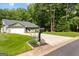 Charming single-story home with a manicured lawn, inviting front porch, and a two-car garage at 431 Hampton Grn, Peachtree City, GA 30269