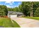 Charming single-Gathering home featuring a well-manicured lawn, long driveway, and a two-car garage at 431 Hampton Grn, Peachtree City, GA 30269