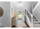 Bright foyer with stairs, a decorative rug, and front door view to the lawn at 431 Hampton Grn, Peachtree City, GA 30269