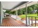 Relaxing front porch with wooden swing, wooden floors, and white railings at 431 Hampton Grn, Peachtree City, GA 30269