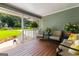 Charming front porch with outdoor furniture, green walls, and lush plants at 431 Hampton Grn, Peachtree City, GA 30269