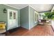 Relaxing front porch with seating, a wooden swing, and views of the yard at 431 Hampton Grn, Peachtree City, GA 30269