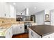 Modern kitchen with white cabinets, stainless steel appliances, and an island with a dark countertop at 431 Hampton Grn, Peachtree City, GA 30269