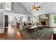 Spacious living room with a stone fireplace, hardwood floors, and an open floor plan at 431 Hampton Grn, Peachtree City, GA 30269