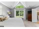 Features a large bed, bedside tables, and an arched window, providing a peaceful retreat with plenty of light at 431 Hampton Grn, Peachtree City, GA 30269