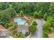 Aerial view of community amenities including pool and playground with lush, mature trees at 2307 Loughridge Dr, Buford, GA 30519