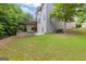 Beautiful green backyard with a pergola, outdoor grill area, and lush grass for Gathering fun and relaxation at 2307 Loughridge Dr, Buford, GA 30519