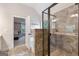 Bathroom features a modern glass shower and large tile flooring, and an open doorway into a bedroom at 2307 Loughridge Dr, Buford, GA 30519