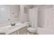 Full bathroom featuring a shower-tub combo, single sink vanity, and white door at 2307 Loughridge Dr, Buford, GA 30519