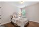 Cozy bedroom showcasing a well-lit space with hardwood floors and an upholstered headboard at 2307 Loughridge Dr, Buford, GA 30519