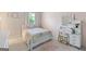Bright bedroom decorated with a pastel color scheme, featuring vanity table and a charming bed at 2307 Loughridge Dr, Buford, GA 30519
