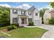 Charming two-story brick home featuring a well-manicured lawn, a two-car garage, and black shutters at 2307 Loughridge Dr, Buford, GA 30519