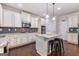 Charming kitchen featuring white cabinets, stainless steel appliances, granite counters, and a center island with bar stool seating at 2307 Loughridge Dr, Buford, GA 30519