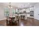 Kitchen with dining table and bar stool seating, stainless appliances and modern decor at 2307 Loughridge Dr, Buford, GA 30519