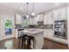 Kitchen with stainless appliances, grey backsplash, granite countertops and island seating at 2307 Loughridge Dr, Buford, GA 30519